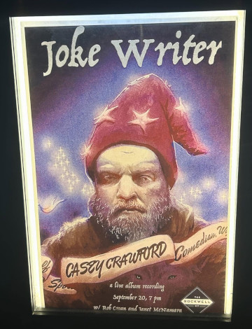 Album cover for comedian Casey Crawford's 'Joke Writer' donning wizard robes and an all mage business gaze towards the viewer